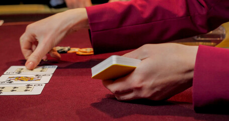 Playing cards in a casino with a man in the background, close-up