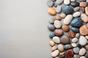 Fototapeta na wymiar Pebble stones on neutral background with space 