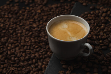 Cup of espresso coffee on a background of coffee beans