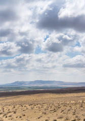 Panoramic view of a mountain range in the desert in cloudy summer weather