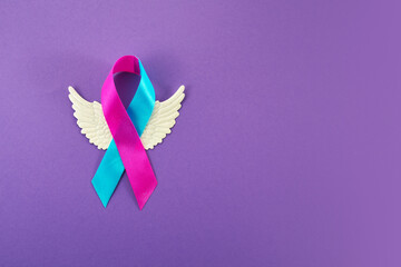 World Prematurity Day with Pink and Blue Ribbon and angel wings