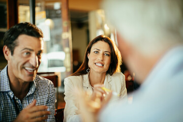 Office colleagues having casual discussion in cafe