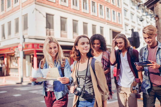 Group of Friends Exploring City with Map and Camera - Powered by Adobe