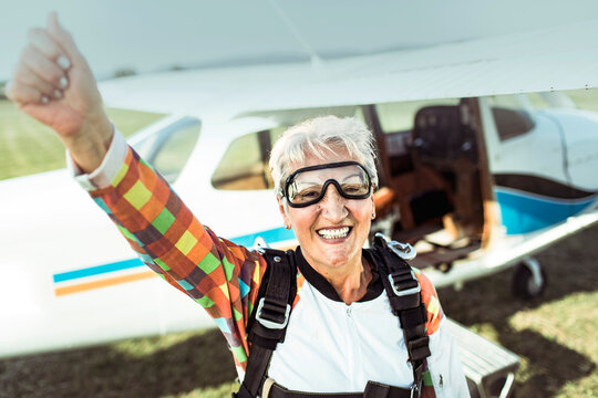 Portrait of excited senior woman before skydiving