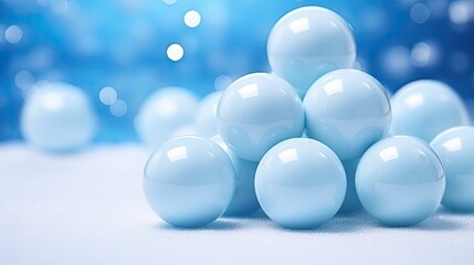  a group of blue balls sitting on top of a white counter top in front of a blue and white background with a blurry image of blue balls in the background.