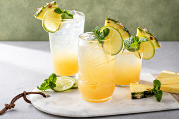 Variety of pineapple and lime cocktails or mocktails, mai tai, refreshing drinks idea