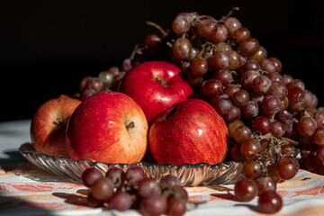 autumn still life. apples and grapes. fruits in a plate. red apple. food. fruits. autumn. 