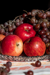 autumn still life. apples and grapes. fruits in a plate. red apple. food. fruits. autumn. 