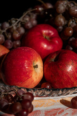 autumn still life. apples and grapes. fruits in a plate. red apple. food. fruits. autumn. 