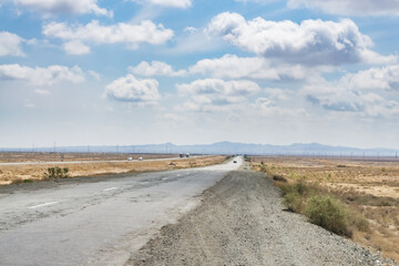 Asphalted highway in the middle of the desert in Uzbekistan, bad road in the desert