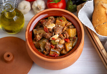 Top view of Turkish dish Guvech - baked meat with eggplant and traditionally served in earthenware pot (Turkish name; etli patlican guvec or patlican tava)