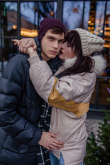 Naklejka premium Couple in love in winter on Christmas eve walking