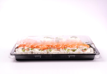 Japanese oriental food tray sushi closed with transparent lid delivery isolated on background top view white background from the front