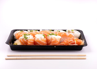 sushi delivery tray isolated on white background with chopsticks facing oriental