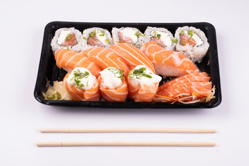sushi delivery tray isolated on white background with chopsticks in top view