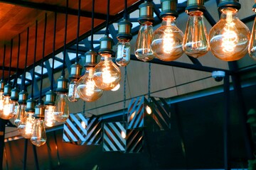 Brightly burning incandescent lamps of different shapes, wine bar design