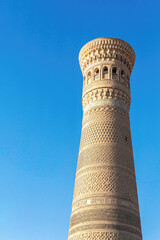 Kalyan Minaret against blue sky. Tourism, travelling and sightseeing. Bukhara, Uzbekistan