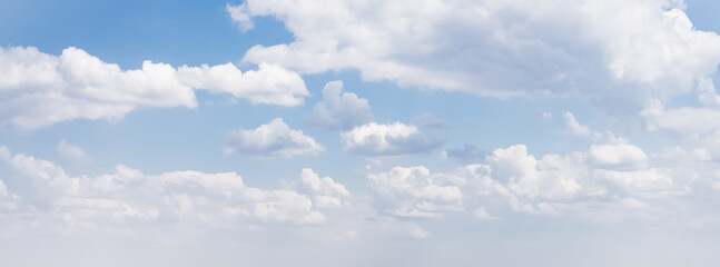 Blue sky with cumulus clouds on a sunny warm summer day