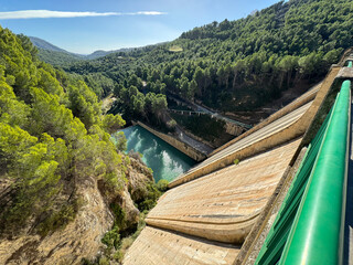 Panoramic view of a dam in a reservoir, in Guadalest village, Spain. The floodgates are open.