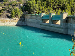 Panoramic view of a dam in a reservoir, in Guadalest village, Spain. The floodgates are open.