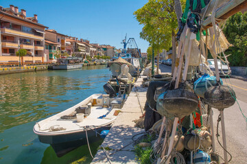 Fototapeta na wymiar Fishing equipment lines a road on the waterfront of Grado in Friuli-Venezia Giulia, north east Italy. August