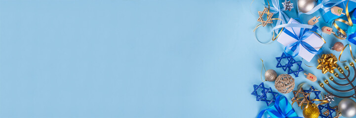 Happy Hanukkah greeting card background. Jewish New Year holiday flat lay with traditional symbols of hanukkah festival, menorah, donuts and decorations copy space