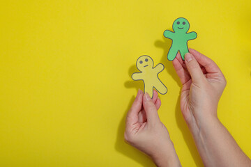 World mental health day. Male hands holding paper men figures with different emotions