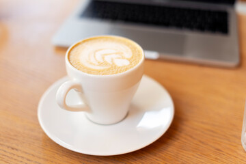 Cup of aroma coffee standing on table, selective focus. Morning coffee break concept 