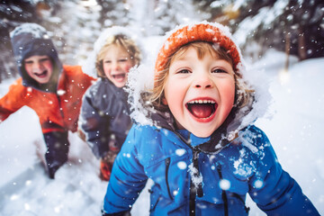 Children playing outdoors on a snowy day. Faces with joy and excitement - obrazy, fototapety, plakaty