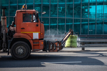 Harvesting equipment. Special transport for cleaning in the city. Orange truck.