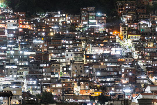 Overcrowded Hillside Favela at Night: A Labyrinth of Life in Compact Spaces
