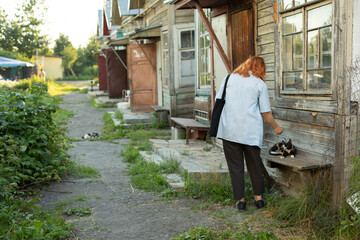 Girl at old house. Student came to poor house. Girl looking for address in ghetto. Details of walk in summer.