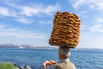 Istanbul, Turkey. November 3, 2023. Turkish street food vendor carries on his head large dish with...