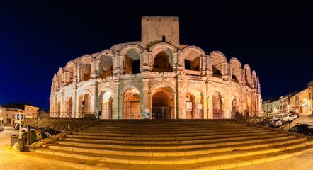 Arles, France - October 1, 2023: Panorama of the illuminated Roman amphitheater and the arena of Arles in the night