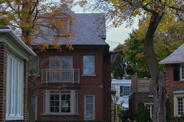 Fall colors Autumn romantic picturesque landscape scenery in Montreal, Quebec Canada Indian Summer natural beauty glowing changing leaves residential houses hoods