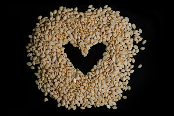 wax for depilation white yellow with the black heart in the middle. banner, flyer, coupon minimal texture. The concept of depilation, waxing, smooth skin without hair