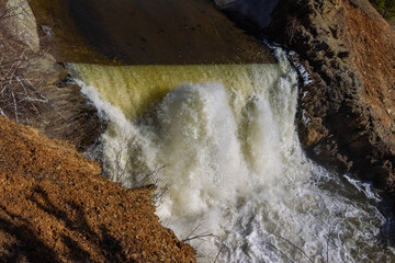 Spring landscape with waterfall on the northern river with stone banks