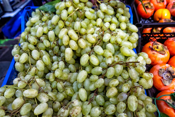 Ripe juicy sweet green grapes on the counter of a fruit store for sale
