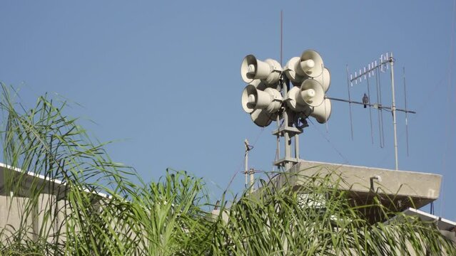 Eight loud alarm siren speakers for civil protection installed on the roof of a defense tower in Israel. This system enhances public safety and emergency alerts. Sound amplifier 
