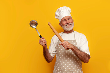 old grandfather chef in apron and hat holds dishes and points to the side on yellow isolated...