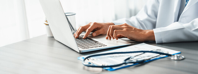 Doctor carefully review detailed medical report with laptop and diagnosing illness for effective healthcare treatment plan for patient in doctor office. Professional medical evaluation. Neoteric - obrazy, fototapety, plakaty