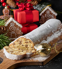 Christmas pastries stollen sprinkled with powdered sugar on the table, festive dessert