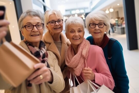 Group of happy grannies making selfie during shopping in mall with shopping bags. 