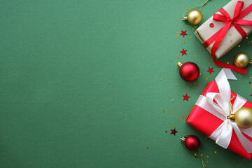 Christmas Present and red decorations at color background. Top view image with copy space.