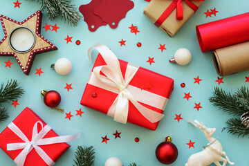 Christmas Present and holiday decorations at blue background. Wrapping christmas present. Top view.