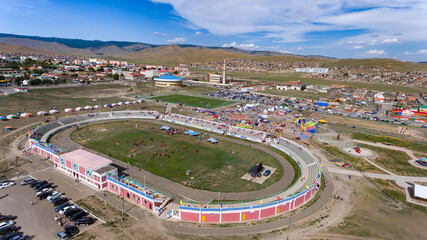 Aerial shot of a bustling Mongolian festival. - obrazy, fototapety, plakaty