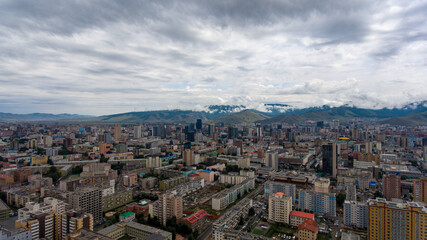 Fototapeta na wymiar Ulaanbaatar's urban sprawl beneath cloudy skies