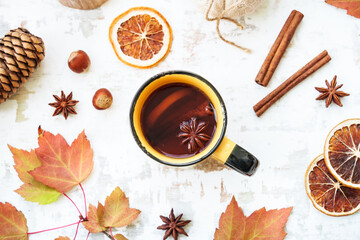 Fall background. Autumn tea, spices, orange leaves, and home decor. Flat lay with copy space.