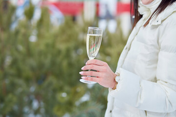 Woman celebrate with glass of champagne outside close up. Happy New Year s Eve