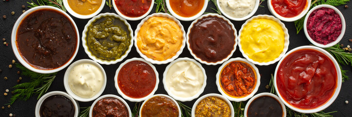 Different types of sauces in bowls with seasonings banner, rosemary and dill, thyme and and peppercorns, top view